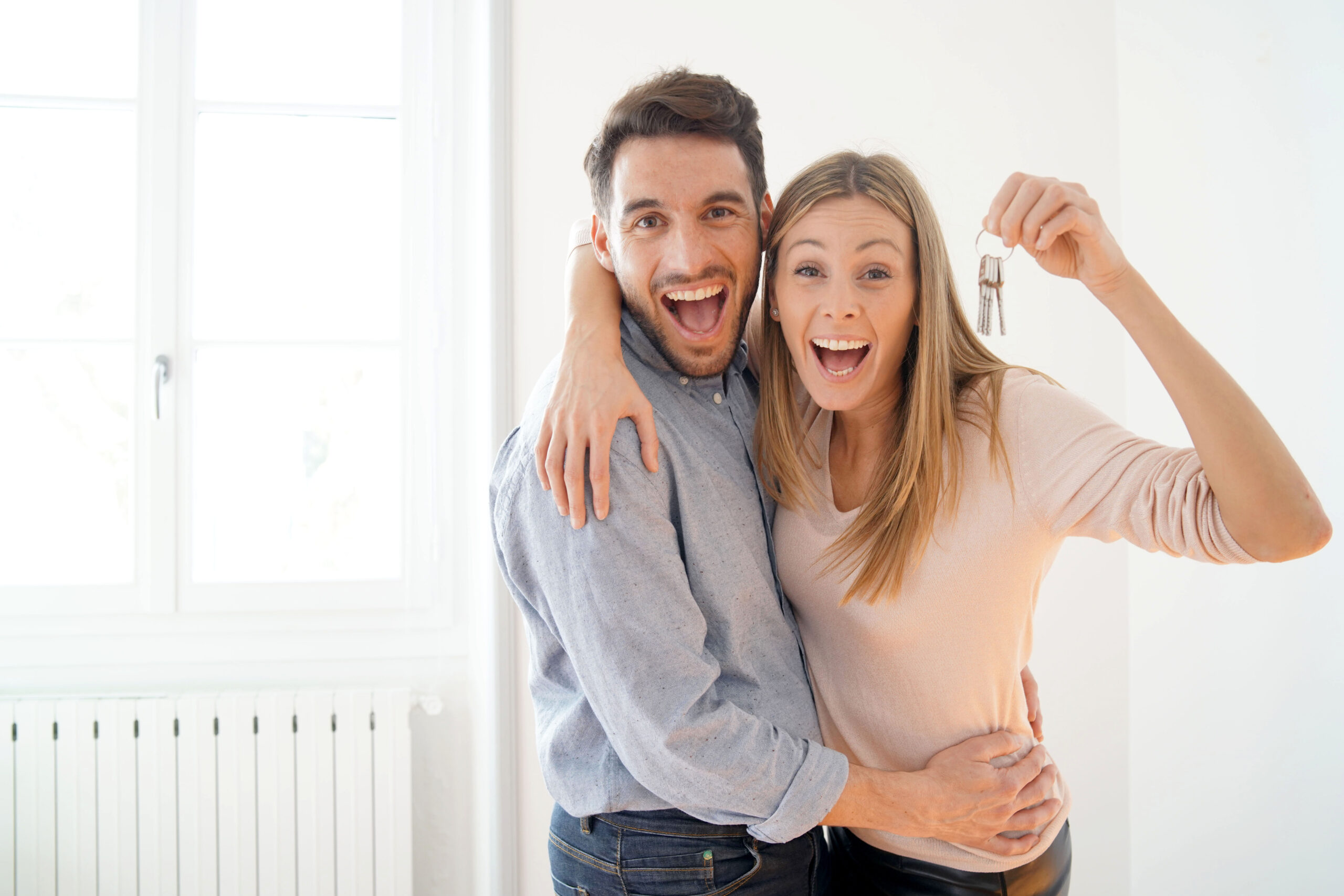 Happy couple with keys to new home